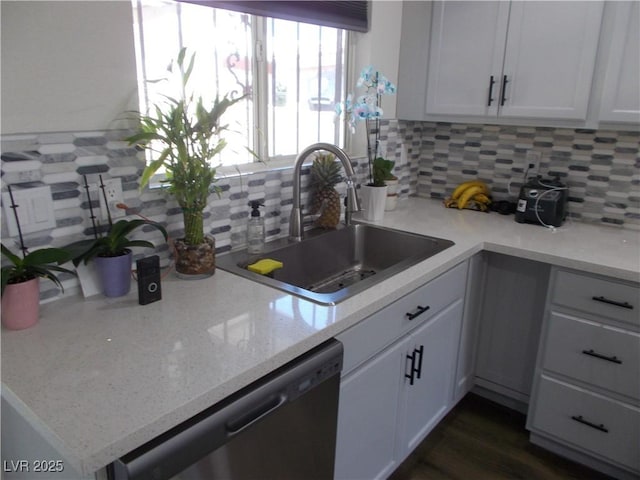 2211 Chipplegate Way N, Las Vegas, NV 89032 - kitchen featuring stainless steel dishwasher, decorative backsplash, white cabinets, and light stone countertops