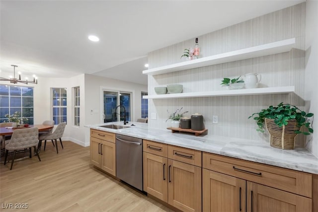 7701 Sea Cliff Way, Las Vegas, NV 89128 - kitchen with stainless steel dishwasher, open shelves, light wood-style flooring, a chandelier, and light stone countertops