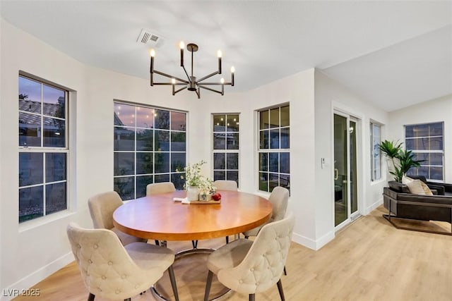 7701 Sea Cliff Way, Las Vegas, NV 89128 - dining area with a chandelier and light wood-style flooring