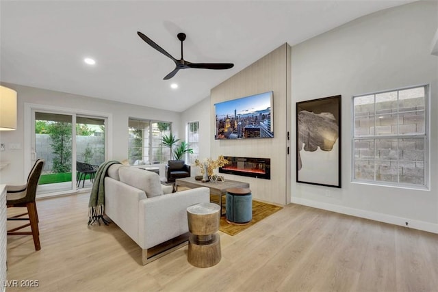7701 Sea Cliff Way, Las Vegas, NV 89128 - living room featuring ceiling fan, a large fireplace, light wood-type flooring, recessed lighting, and high vaulted ceiling