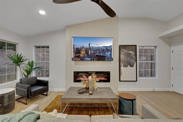 7701 Sea Cliff Way, Las Vegas, NV 89128 - living area featuring lofted ceiling, a ceiling fan, wood finished floors, a glass covered fireplace, and recessed lighting