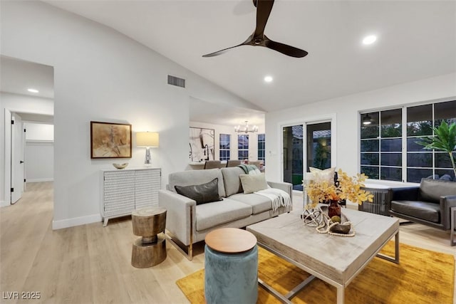 7701 Sea Cliff Way, Las Vegas, NV 89128 - living room featuring vaulted ceiling, a chandelier, a ceiling fan, light wood finished floors, and recessed lighting