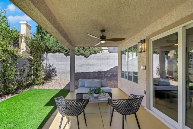 7701 Sea Cliff Way, Las Vegas, NV 89128 - fenced backyard with an outdoor living space, a ceiling fan, and a patio area
