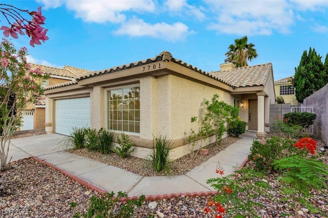 7701 Sea Cliff Way, Las Vegas, NV 89128 - view of home's exterior featuring stucco siding, an attached garage, driveway, and a tiled roof