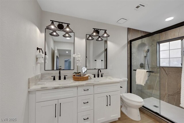 7701 Sea Cliff Way, Las Vegas, NV 89128 - full bathroom featuring a shower stall, double vanity, wood finished floors, and a baseboard radiator