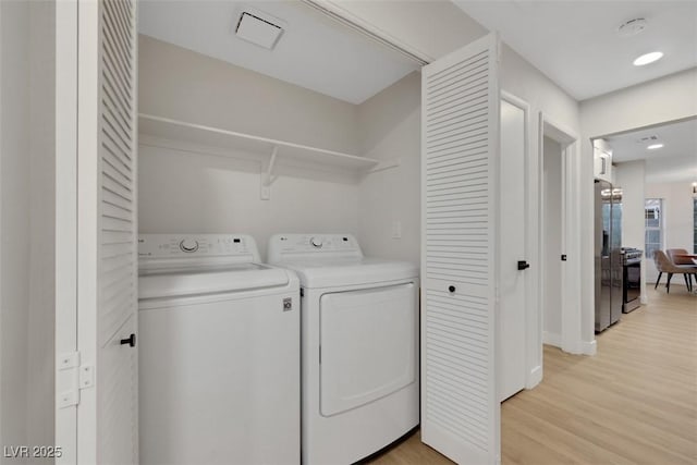 7701 Sea Cliff Way, Las Vegas, NV 89128 - laundry room featuring independent washer and dryer and light wood-type flooring