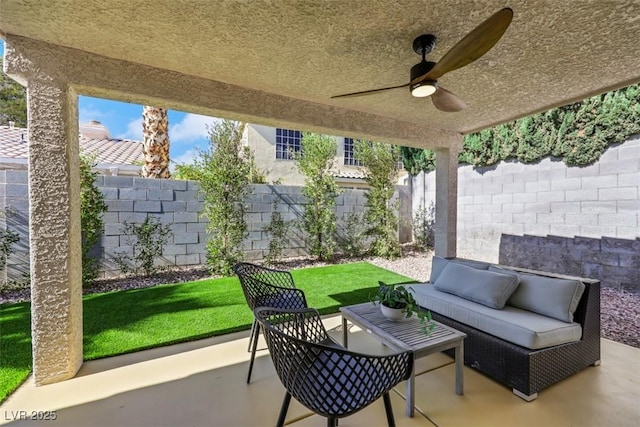 7701 Sea Cliff Way, Las Vegas, NV 89128 - fenced backyard with a patio, an outdoor hangout area, and a ceiling fan