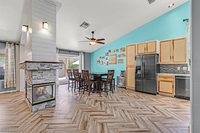 100 Crossfoot Terrace Ct, Henderson, NV 89002 - dining room featuring vaulted ceiling, ceiling fan, and a stone fireplace