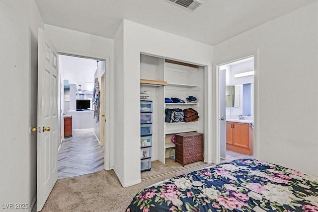 100 Crossfoot Terrace Ct, Henderson, NV 89002 - bedroom with light colored carpet, a closet, and ensuite bathroom