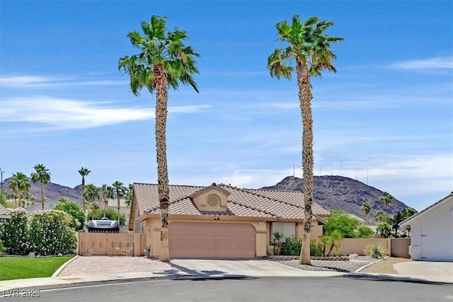 100 Crossfoot Terrace Ct, Henderson, NV 89002 - view of front of property with a garage, stucco siding, a tile roof, and a mountain view
