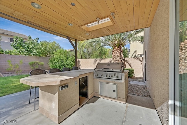 9044 Blue Raven Ave Unit R, Las Vegas, NV 89143 - fenced backyard featuring exterior kitchen, a patio, and exterior bar