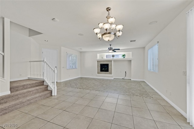 9044 Blue Raven Ave Unit R, Las Vegas, NV 89143 - unfurnished living room with light tile patterned floors, stairs, a chandelier, and light colored carpet