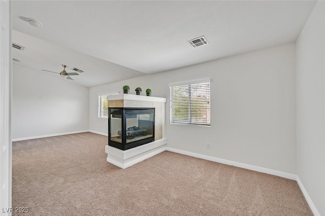 9044 Blue Raven Ave Unit R, Las Vegas, NV 89143 - unfurnished living room with carpet floors, a multi sided fireplace, healthy amount of natural light, and lofted ceiling