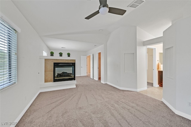 9044 Blue Raven Ave Unit R, Las Vegas, NV 89143 - unfurnished living room featuring carpet flooring, a ceiling fan, vaulted ceiling, and a tile fireplace