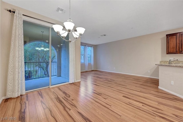 7856 Carysford Ave, Las Vegas, NV 89178 - unfurnished dining area featuring a chandelier and light wood-style flooring