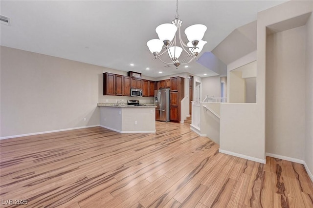 7856 Carysford Ave, Las Vegas, NV 89178 - kitchen featuring stainless steel appliances, a chandelier, light countertops, open floor plan, and a peninsula