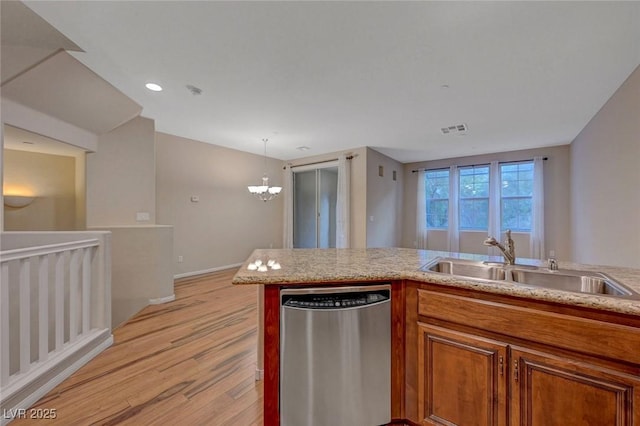 7856 Carysford Ave, Las Vegas, NV 89178 - kitchen with dishwasher, light wood finished floors, brown cabinetry, a chandelier, and decorative light fixtures
