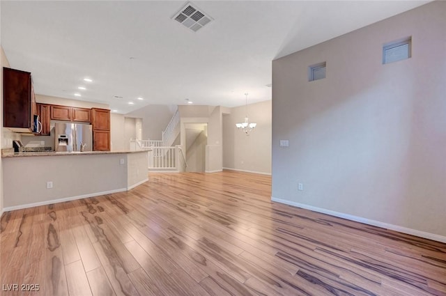7856 Carysford Ave, Las Vegas, NV 89178 - unfurnished living room featuring a chandelier, light wood-type flooring, recessed lighting, and stairs