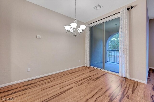 7856 Carysford Ave, Las Vegas, NV 89178 - unfurnished dining area featuring wood finished floors and a chandelier