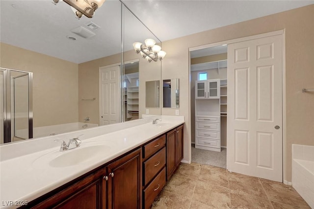 7856 Carysford Ave, Las Vegas, NV 89178 - bathroom featuring a bath, double vanity, and a spacious closet