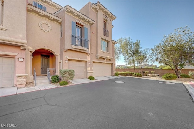 7856 Carysford Ave, Las Vegas, NV 89178 - view of front of house featuring stucco siding, an attached garage, and a balcony