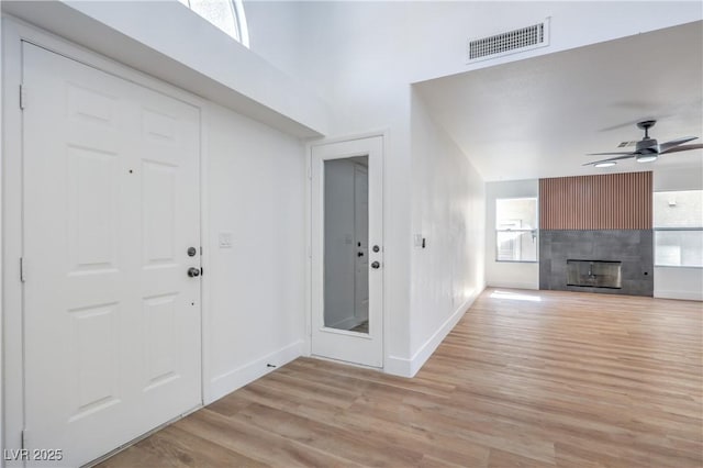6420 Rosemount Ave, Las Vegas, NV 89156 - entryway featuring light wood finished floors, ceiling fan, and a tiled fireplace
