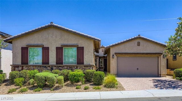 800 Rosewater Dr, Henderson, NV 89011 - view of front of house featuring stucco siding, an attached garage, driveway, and stone siding