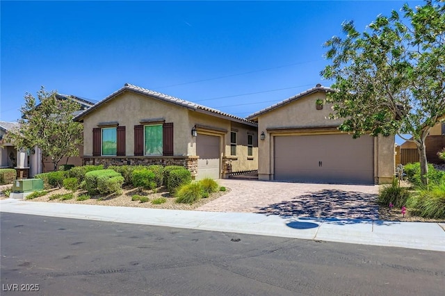 800 Rosewater Dr, Henderson, NV 89011 - view of front of home featuring a garage, stucco siding, driveway, and stone siding