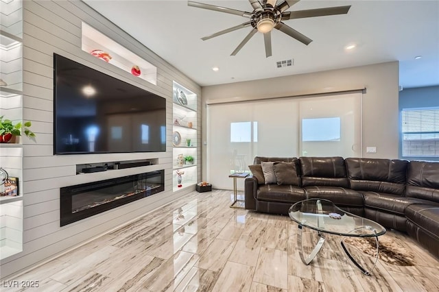 800 Rosewater Dr, Henderson, NV 89011 - living area featuring a glass covered fireplace, a ceiling fan, healthy amount of natural light, and recessed lighting