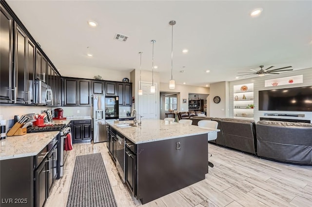 800 Rosewater Dr, Henderson, NV 89011 - kitchen with stainless steel appliances, ceiling fan, open floor plan, hanging light fixtures, and recessed lighting