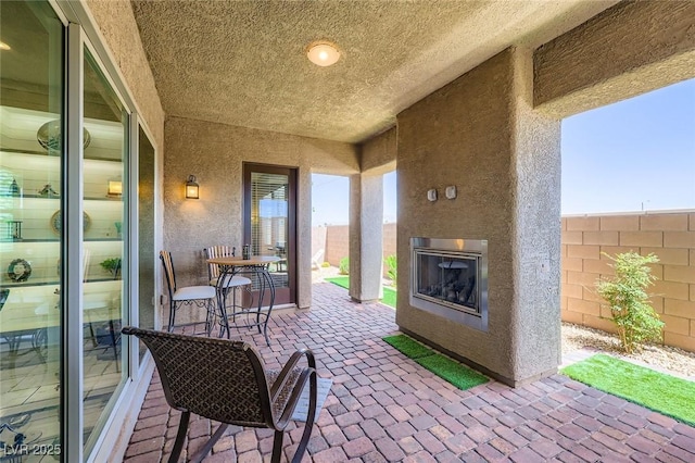 800 Rosewater Dr, Henderson, NV 89011 - fenced backyard with a patio area and a glass covered fireplace