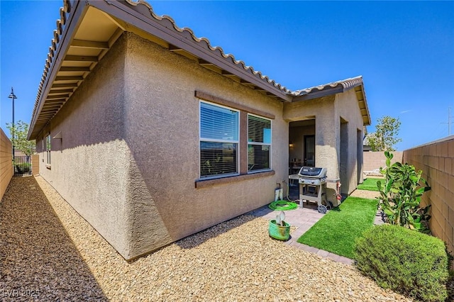 800 Rosewater Dr, Henderson, NV 89011 - view of side of property featuring stucco siding, a fenced backyard, and a patio area