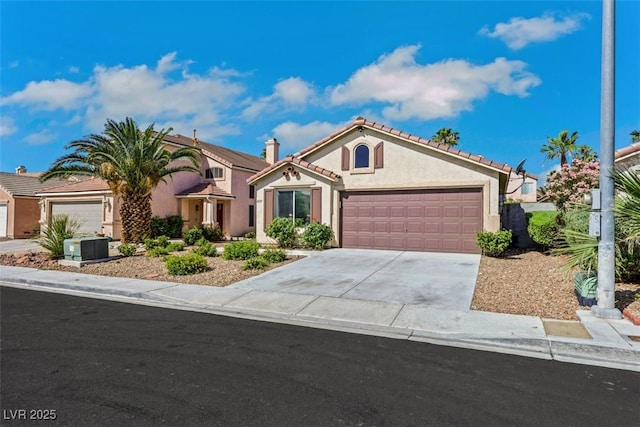 6035 Shadow Oak Dr, North Las Vegas, NV 89031 - mediterranean / spanish-style house featuring stucco siding, an attached garage, driveway, and a tiled roof