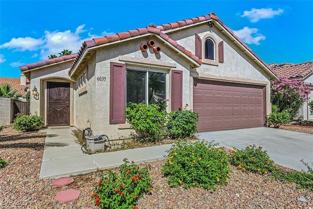 6035 Shadow Oak Dr, North Las Vegas, NV 89031 - mediterranean / spanish-style house featuring driveway, stucco siding, a garage, and a tile roof