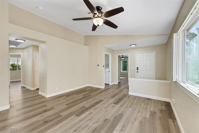 6035 Shadow Oak Dr, North Las Vegas, NV 89031 - spare room with light wood finished floors, a ceiling fan, vaulted ceiling, and washer / clothes dryer