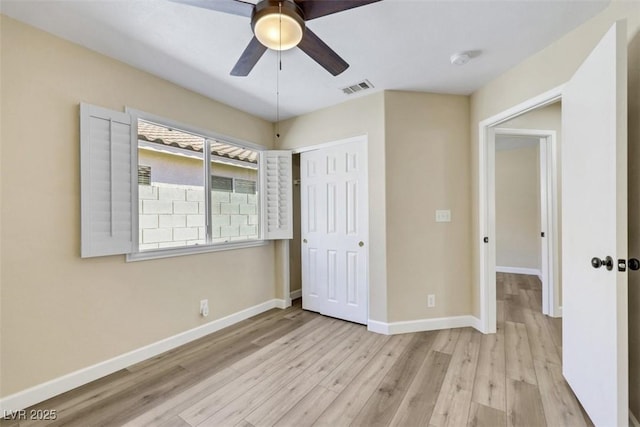 6035 Shadow Oak Dr, North Las Vegas, NV 89031 - unfurnished bedroom with wood finished floors, a closet, and a ceiling fan