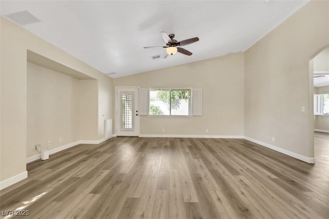 6035 Shadow Oak Dr, North Las Vegas, NV 89031 - unfurnished living room featuring arched walkways, lofted ceiling, a ceiling fan, and wood finished floors