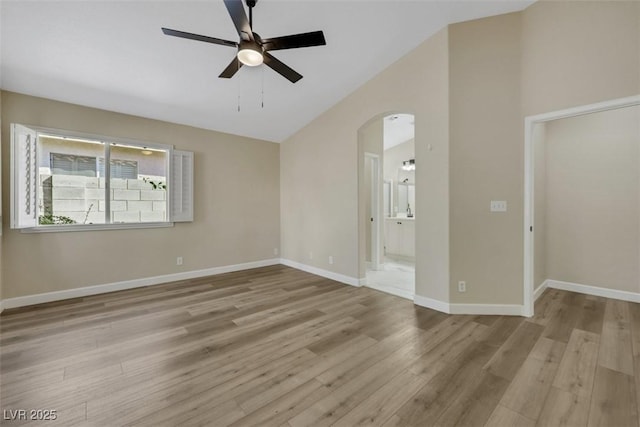 6035 Shadow Oak Dr, North Las Vegas, NV 89031 - empty room with a ceiling fan, lofted ceiling, wood finished floors, and arched walkways