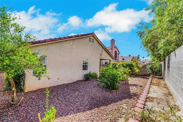 6035 Shadow Oak Dr, North Las Vegas, NV 89031 - view of side of home with stucco siding and a fenced backyard