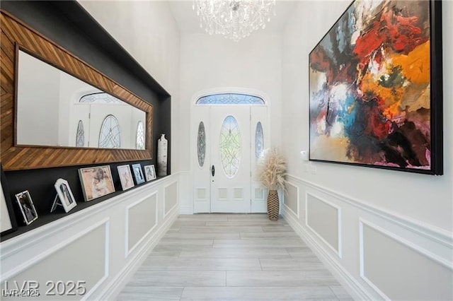 764 Ricota Ct, Henderson, NV 89012 - entrance foyer featuring a decorative wall, a chandelier, wainscoting, and a towering ceiling