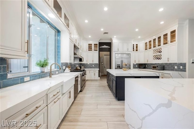 764 Ricota Ct, Henderson, NV 89012 - kitchen featuring stainless steel appliances, tasteful backsplash, white cabinets, light stone countertops, and recessed lighting