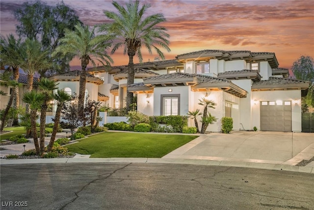 764 Ricota Ct, Henderson, NV 89012 - view of front facade featuring driveway, stucco siding, a yard, a tile roof, and a garage