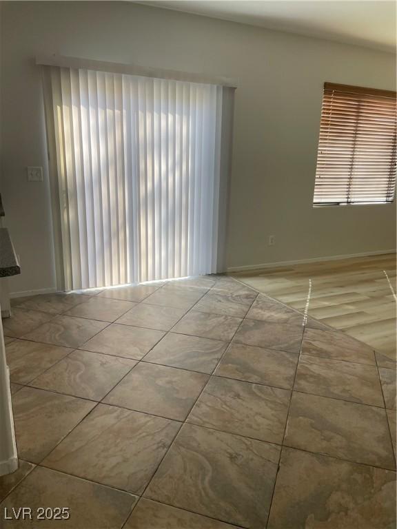908 Shining Rose Pl, Henderson, NV 89052 - spare room with healthy amount of natural light and tile patterned floors