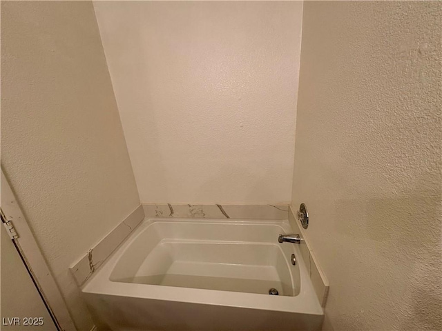 5751 E Hacienda Ave Unit 226, Las Vegas, NV 89122 - bathroom with a garden tub and a textured wall
