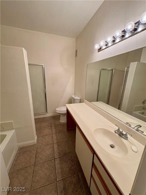 5751 E Hacienda Ave Unit 226, Las Vegas, NV 89122 - bathroom featuring a shower stall, a bath, vanity, and tile patterned floors