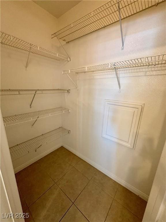5751 E Hacienda Ave Unit 226, Las Vegas, NV 89122 - walk in closet with tile patterned floors