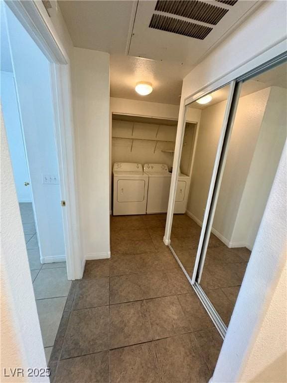 5751 E Hacienda Ave Unit 226, Las Vegas, NV 89122 - corridor featuring washing machine and clothes dryer and tile patterned flooring
