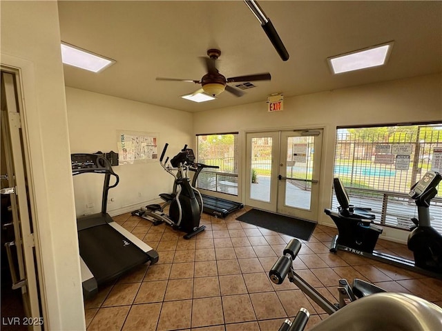 5751 E Hacienda Ave Unit 226, Las Vegas, NV 89122 - exercise room featuring a skylight, ceiling fan, french doors, and light tile patterned floors