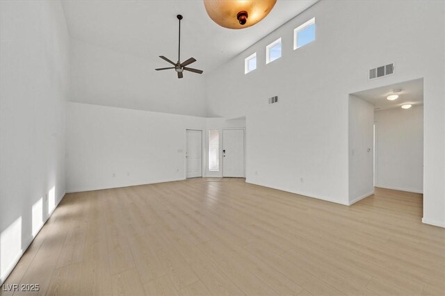 4708 Cohiba Way N, Las Vegas, NV 89031 - unfurnished living room with high vaulted ceiling, a ceiling fan, and light wood finished floors
