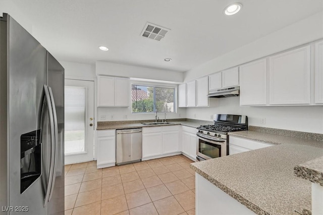 4708 Cohiba Way N, Las Vegas, NV 89031 - kitchen featuring stainless steel appliances, under cabinet range hood, light tile patterned floors, white cabinets, and recessed lighting